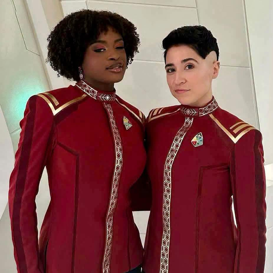 Crew wearing triangular awards